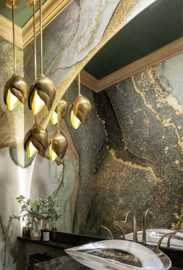 Murano Glass sink set against a striking, swirled green, black and gold statement wall