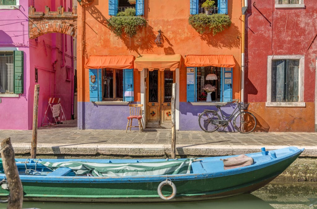 Burano island canal, colorful houses and boats, Italy, Europe