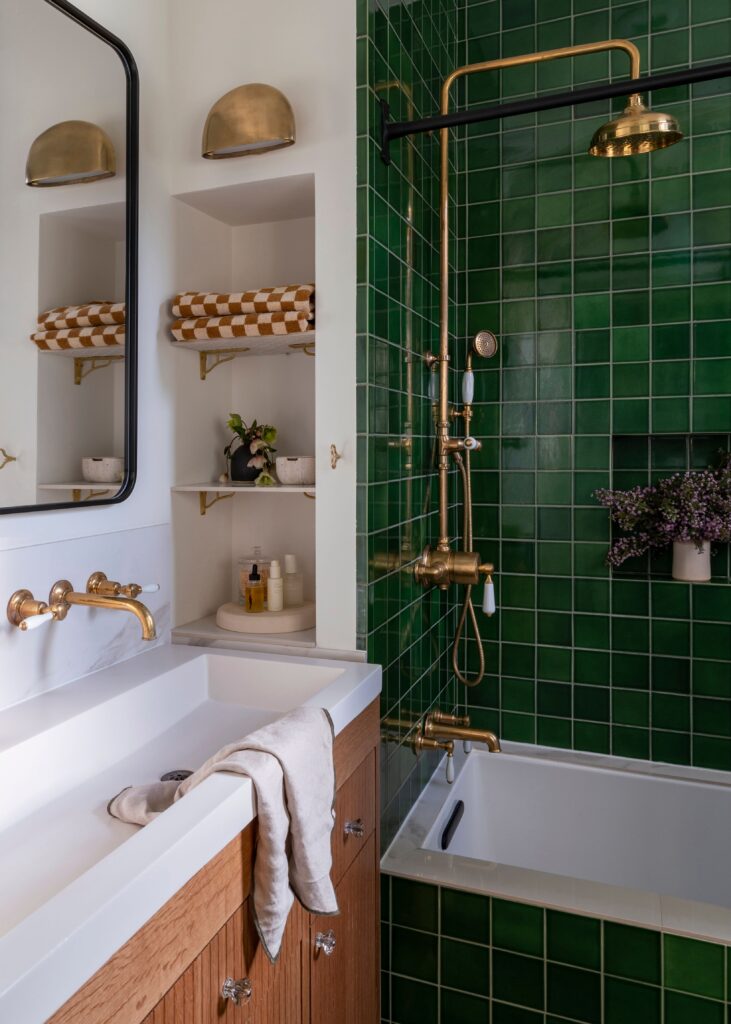 Bright green, square tiles stacked onto one another create the perfect visual for one of our favorite bathroom design trends of 2024