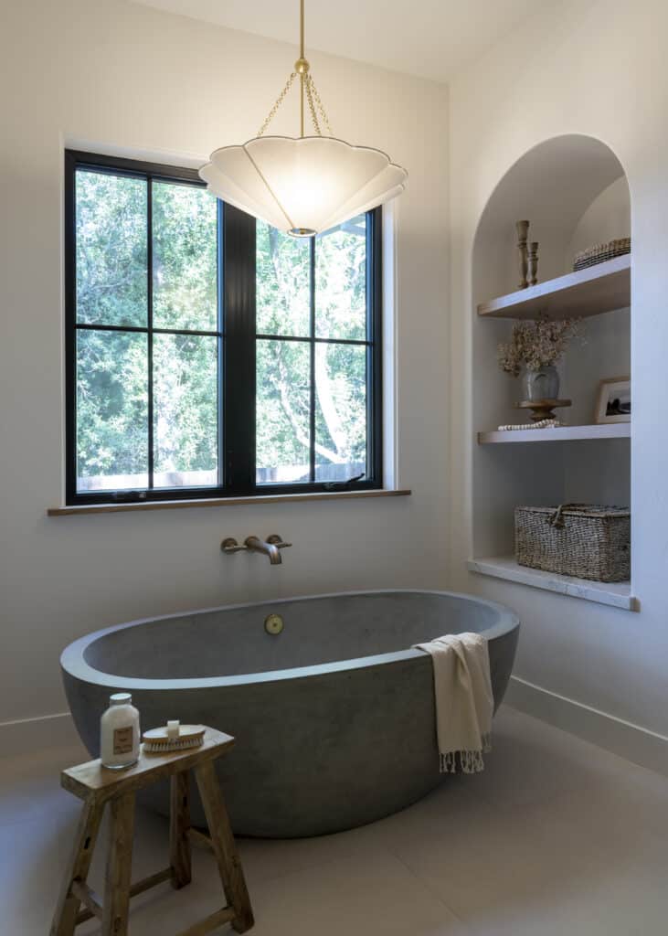 Designer uses a NativeStone concrete tub in color Ash to perfectly complement warm minimalism design style