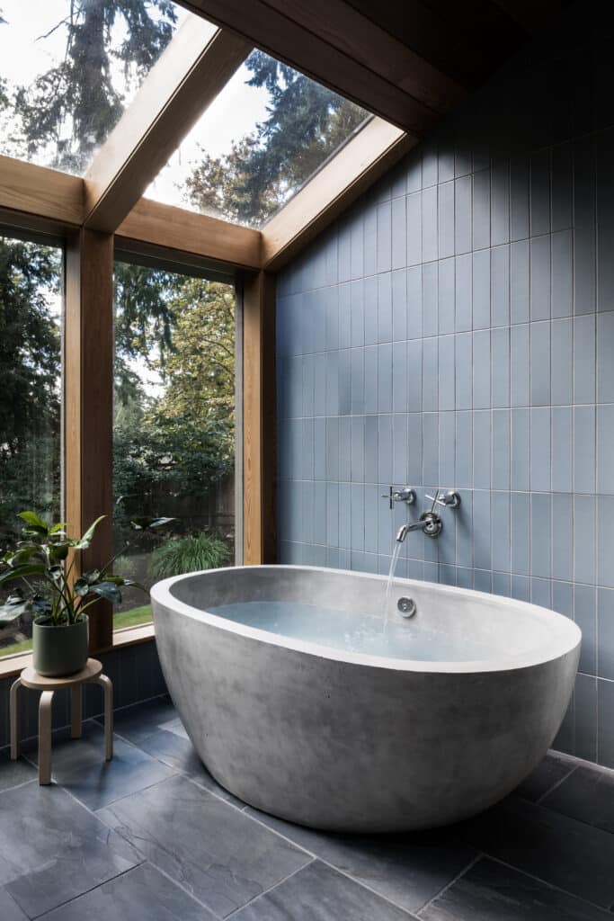 Midcentury modern style design featuring a Native Trails concrete NativeStone freestanding bathtub in ash grey.