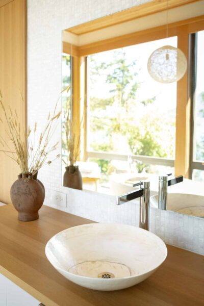 An artisanal sink is the standout in this light-filled bathroom design